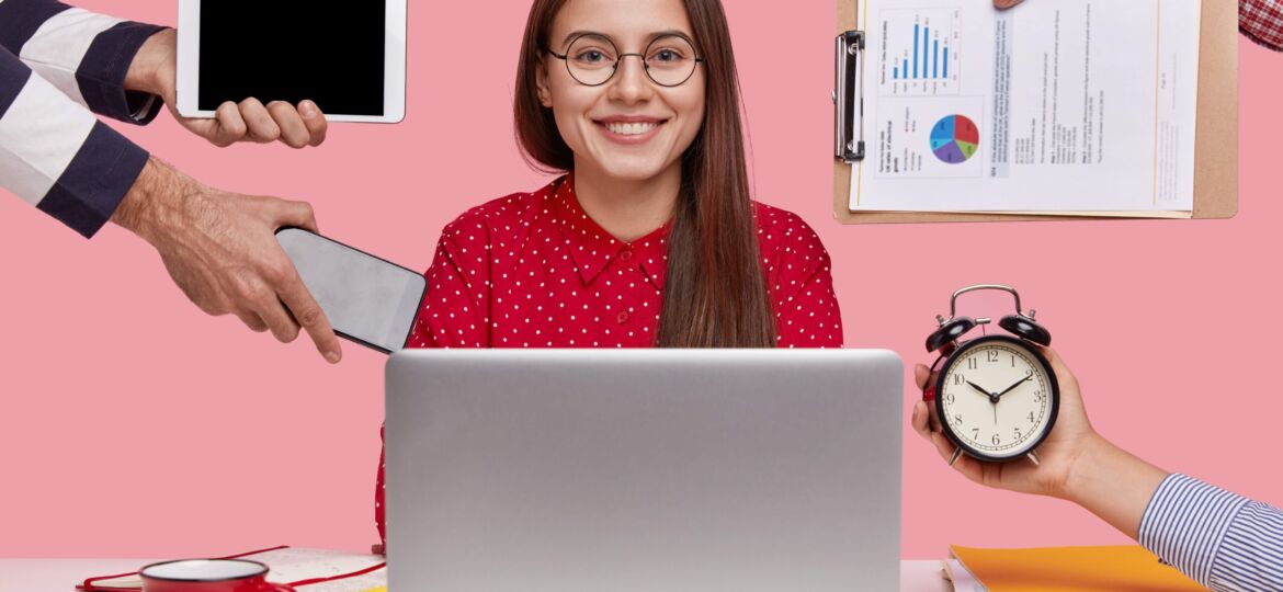 horizontal-shot-smiling-beautiful-woman-red-shirt-sits-front-opened-laptop-computer (1)