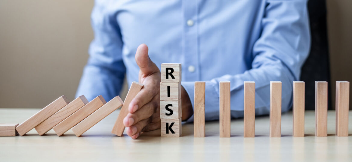 Businessman hand Stopping Falling wooden Blocks or Dominoes. Bus