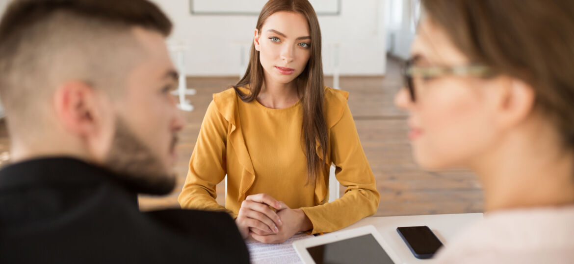 Pretty girl in blouse dreamily looking at employers while spendi