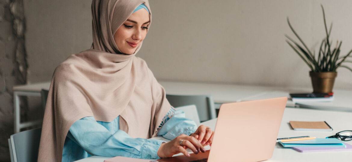 modern muslim woman in hijab in office room