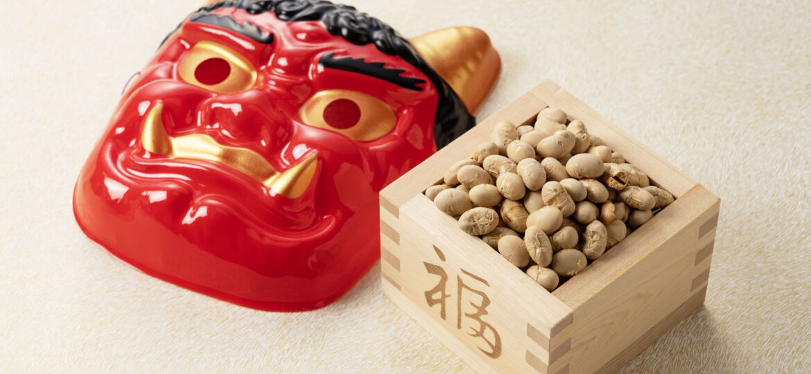 Beans for bean-throwing and masks of ogres placed on a Japanese-