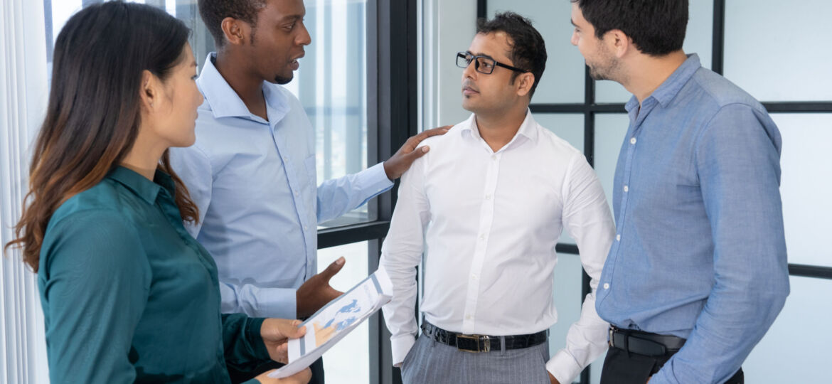 Four young business people discussing negotiation strategy