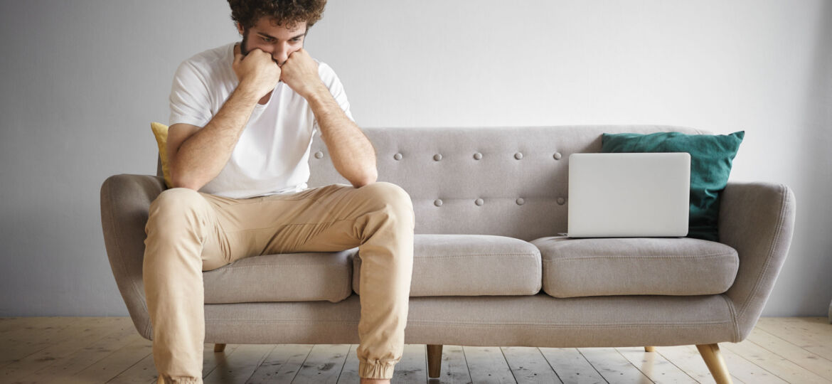 Horizontal shot of unemployed young male wearing white t-shirt a