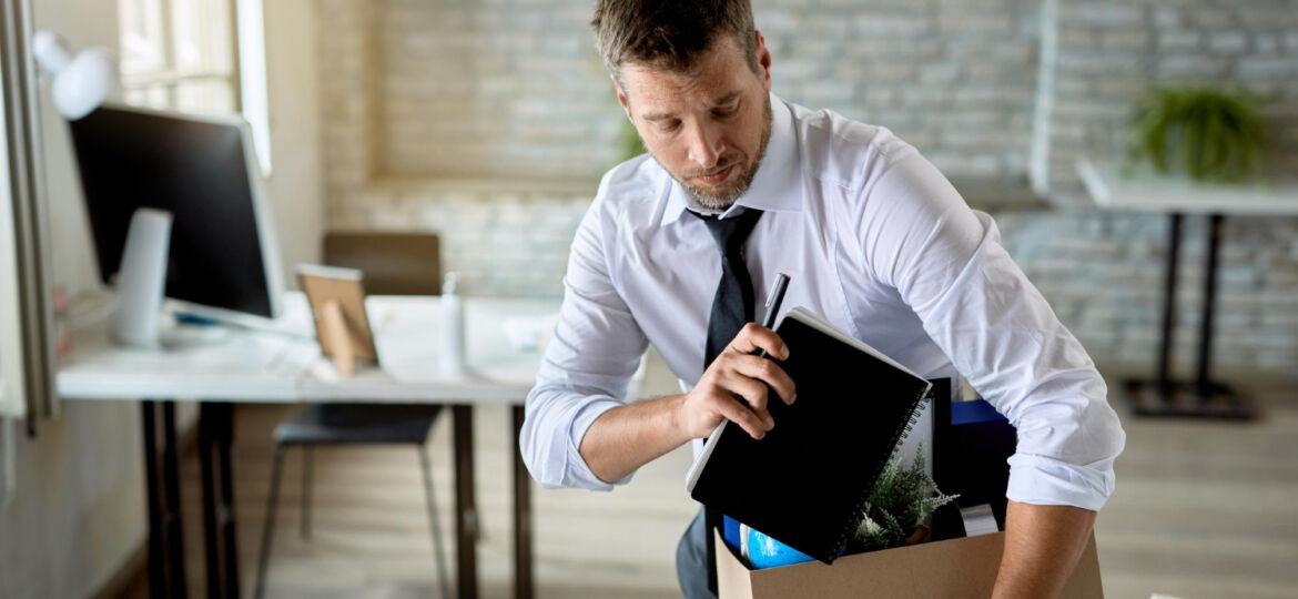 mid-adult-businessman-getting-fired-packing-his-stuff-office