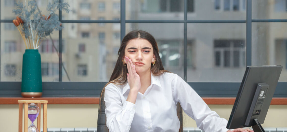 Portrait of a thoughtful businesswoman sitting at the desk and thinking