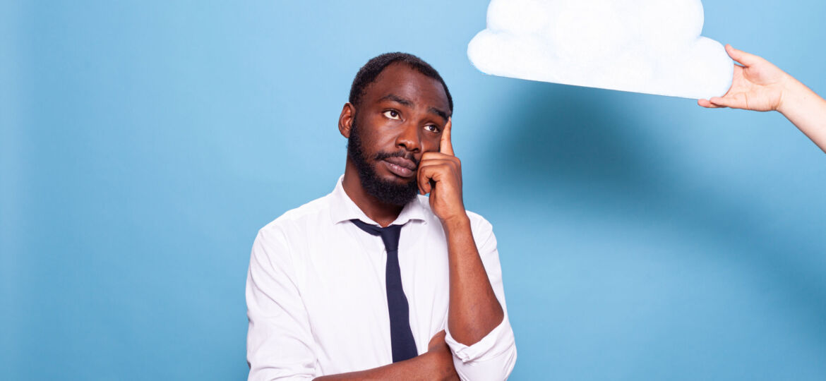 Professional businessman looking at white paper idea cloud