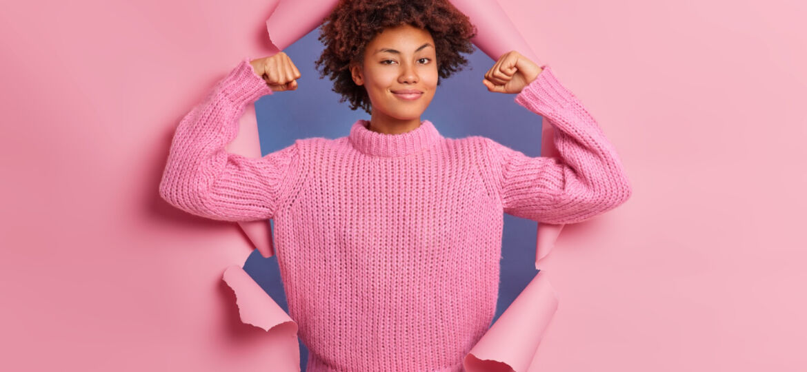 self-assured-beautiful-young-afro-american-woman-raises-arms-shows-biceps-being-strong-powerful