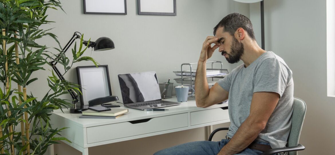 tired-man-sitting-his-home-desk