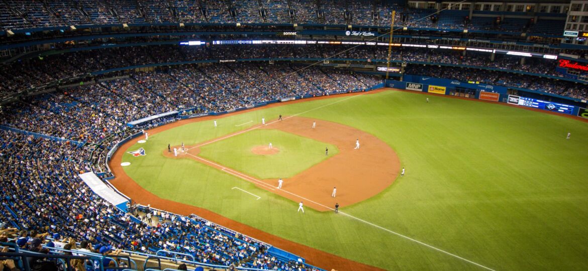 Horizontal shot of crowded Yankee baseball stadium and players in the field