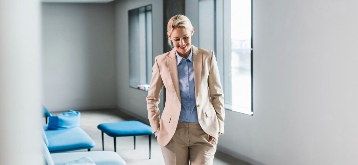 Professional woman smiling in a suit practicing a good work-life balance