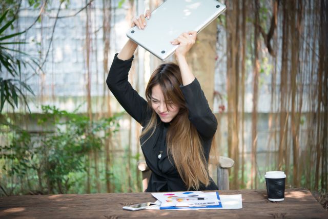 Business Woman getting crazy with of her laptop.