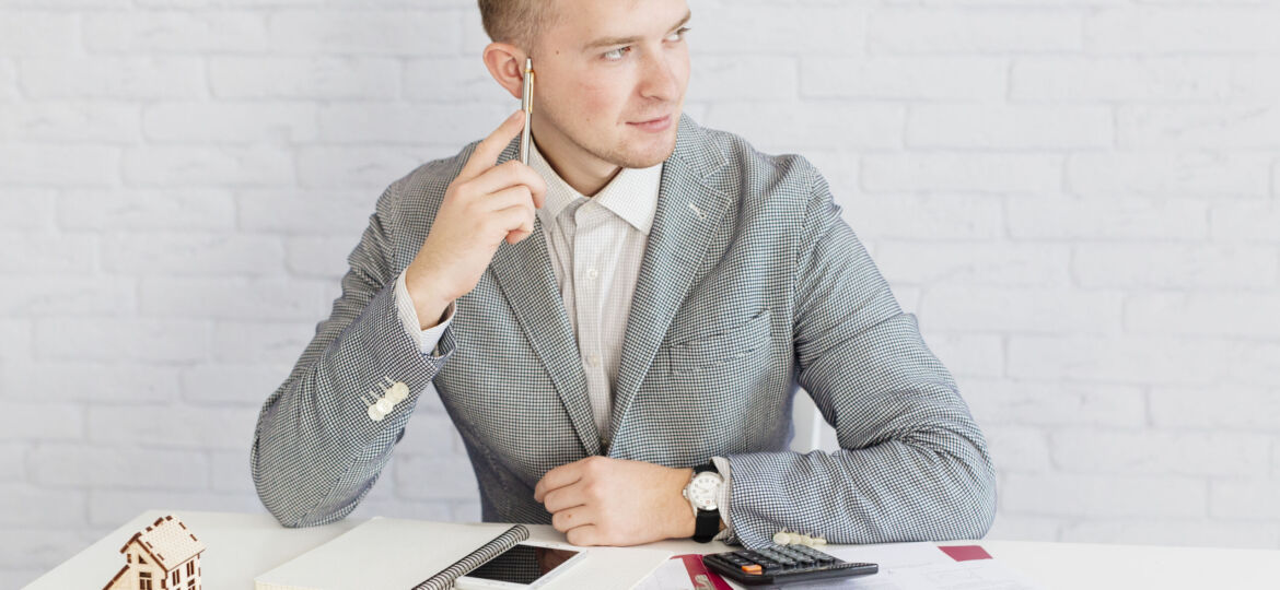 pensive-realtor-sitting-office