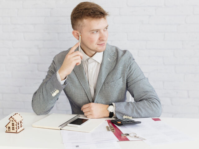 pensive-realtor-sitting-office