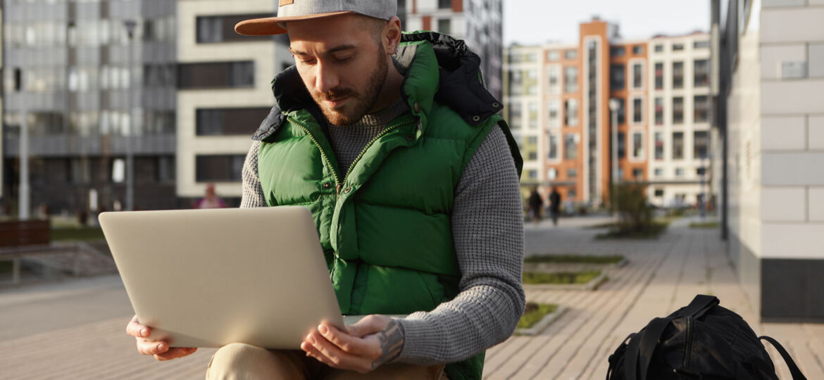 Picture of serious focused young male with stubble surfing inter