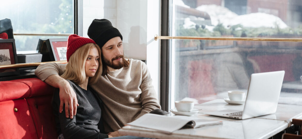 Side view of hipsters looking at laptop