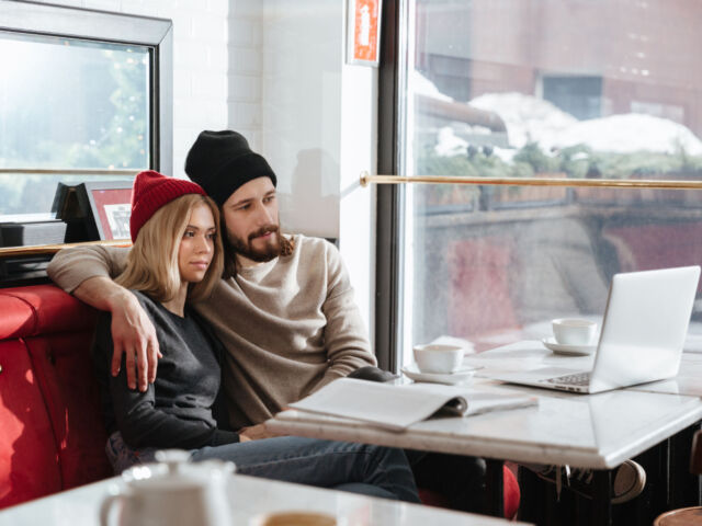Side view of hipsters looking at laptop