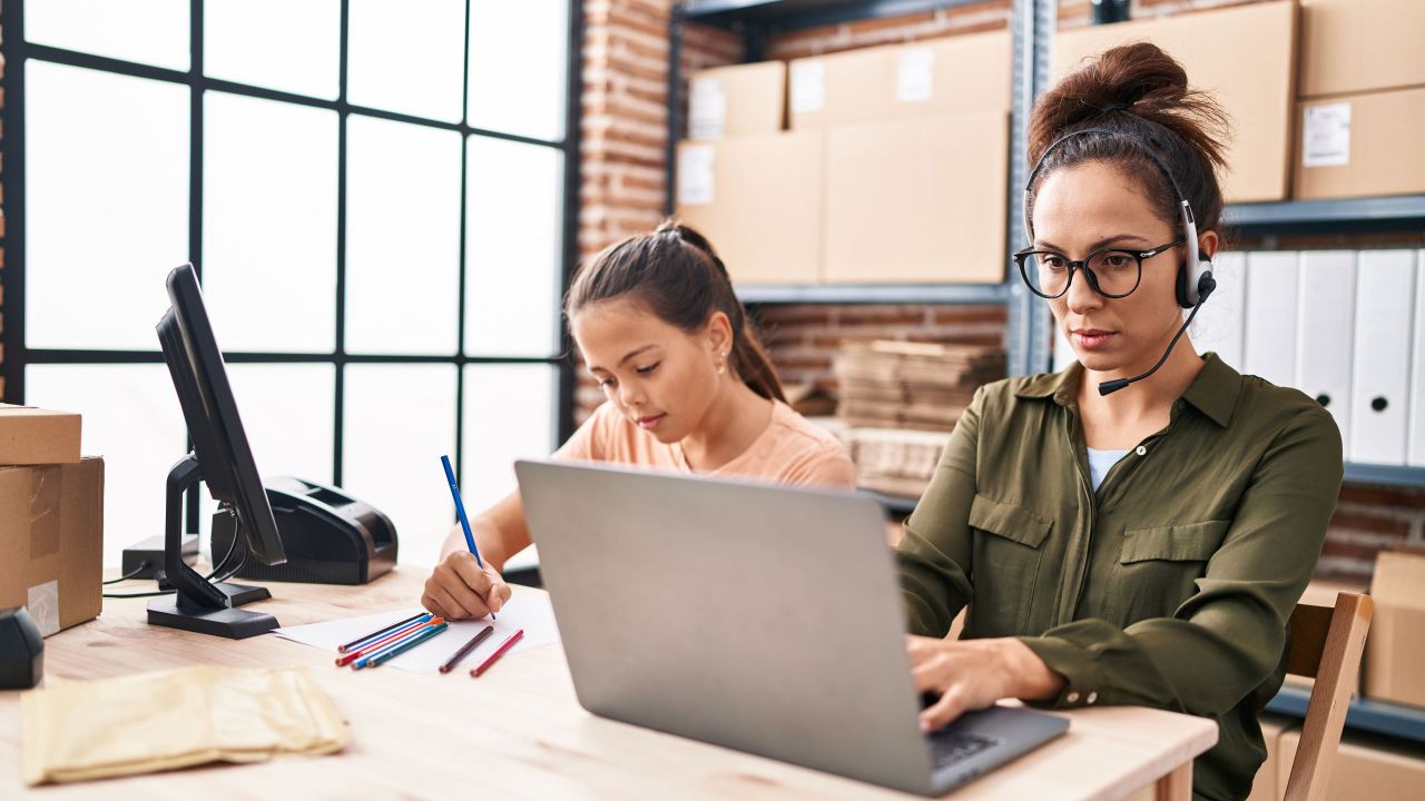 Young mother and daughter working at the office and doing homework thinking attitude and sober expression looking self confident Young mother and daughter working at the office and doing homework thinking attitude and sober expression looking self confident