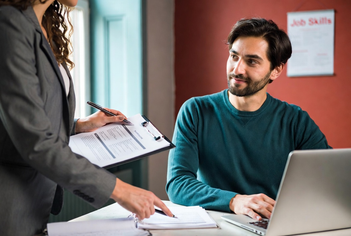 Career advisor helping a job seeker review a resume and career plan