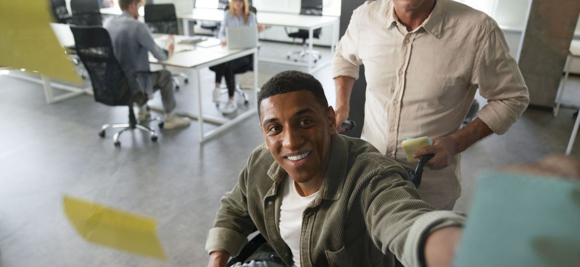 disabled-man-wheelchair-working-his-office-job