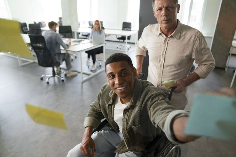 disabled-man-wheelchair-working-his-office-job