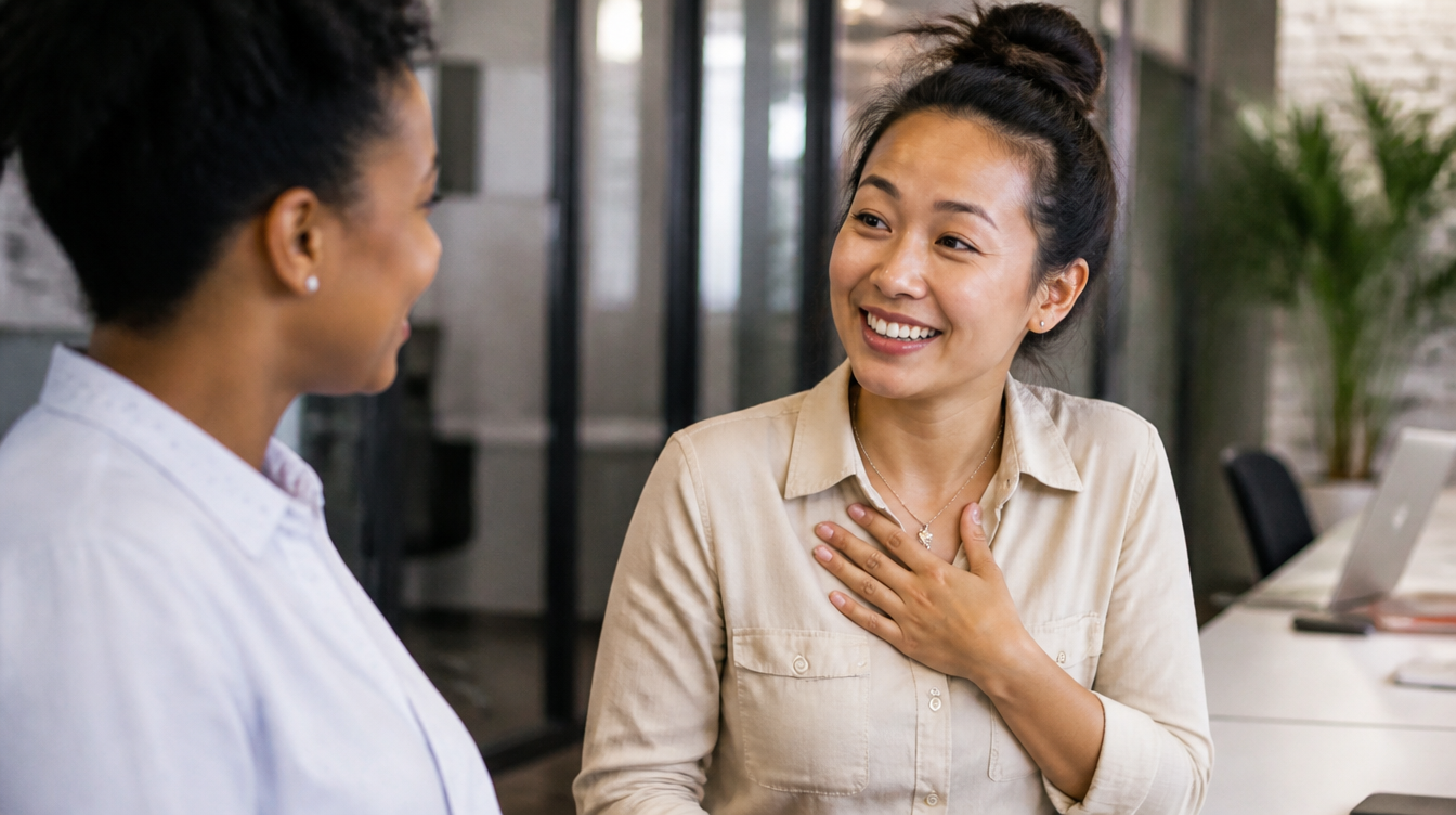 Two coworkers having a genuine conversation in the workplace